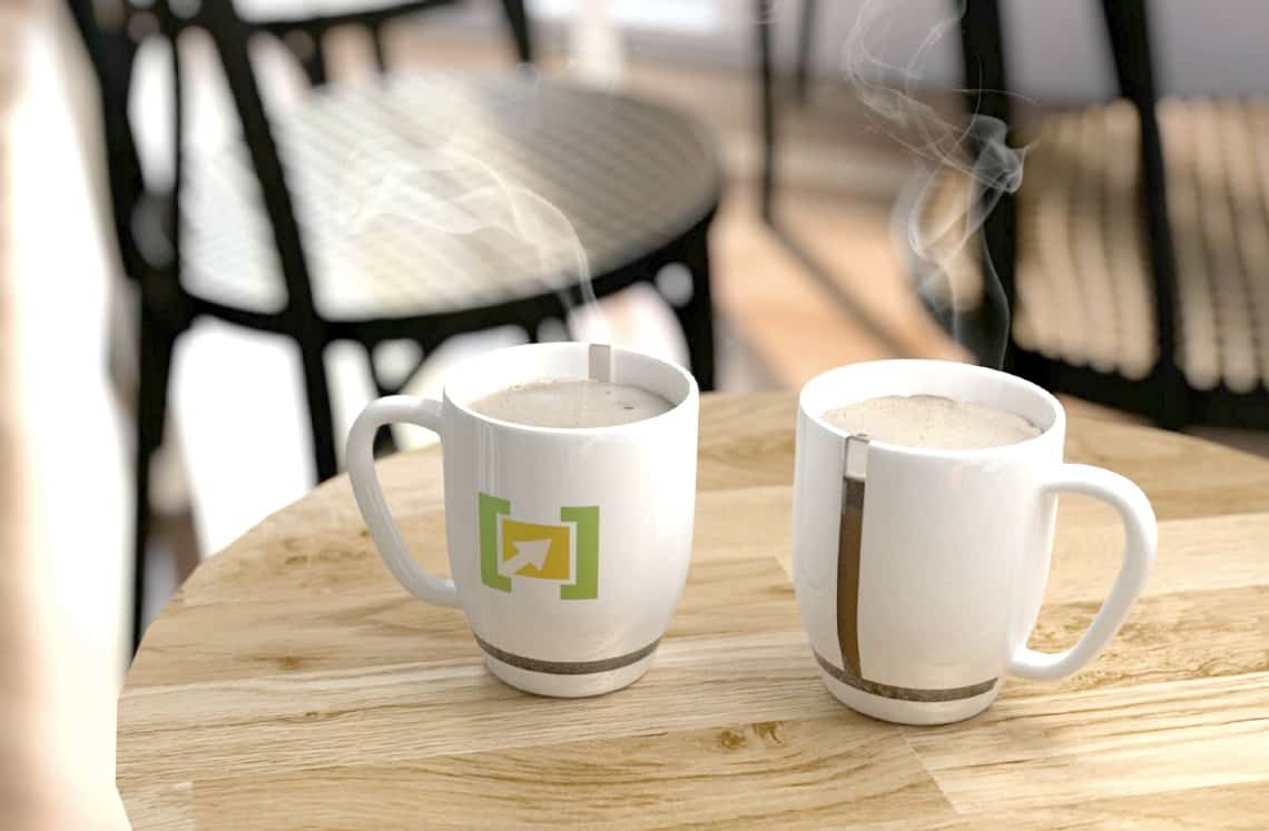 Steaming coffee mugs on table.