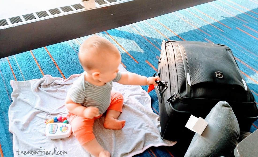 Baby pulls on luggage handle.