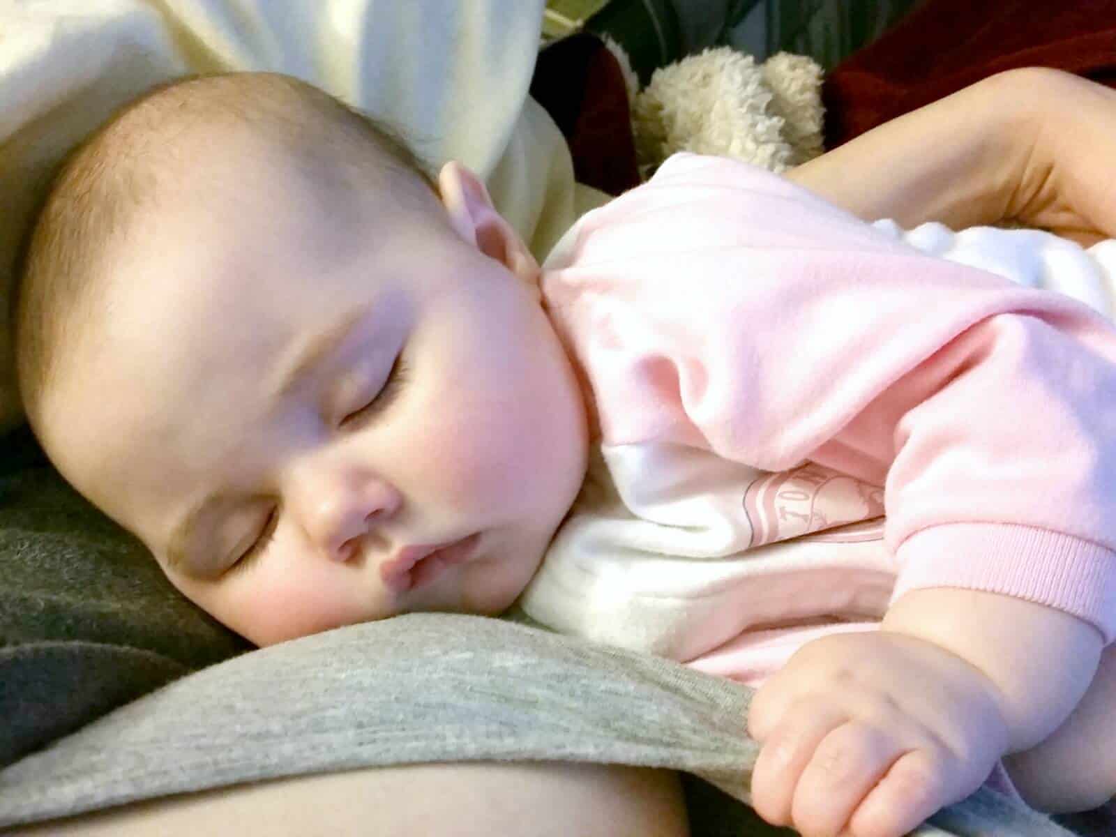 Baby girl asleep after nursing.