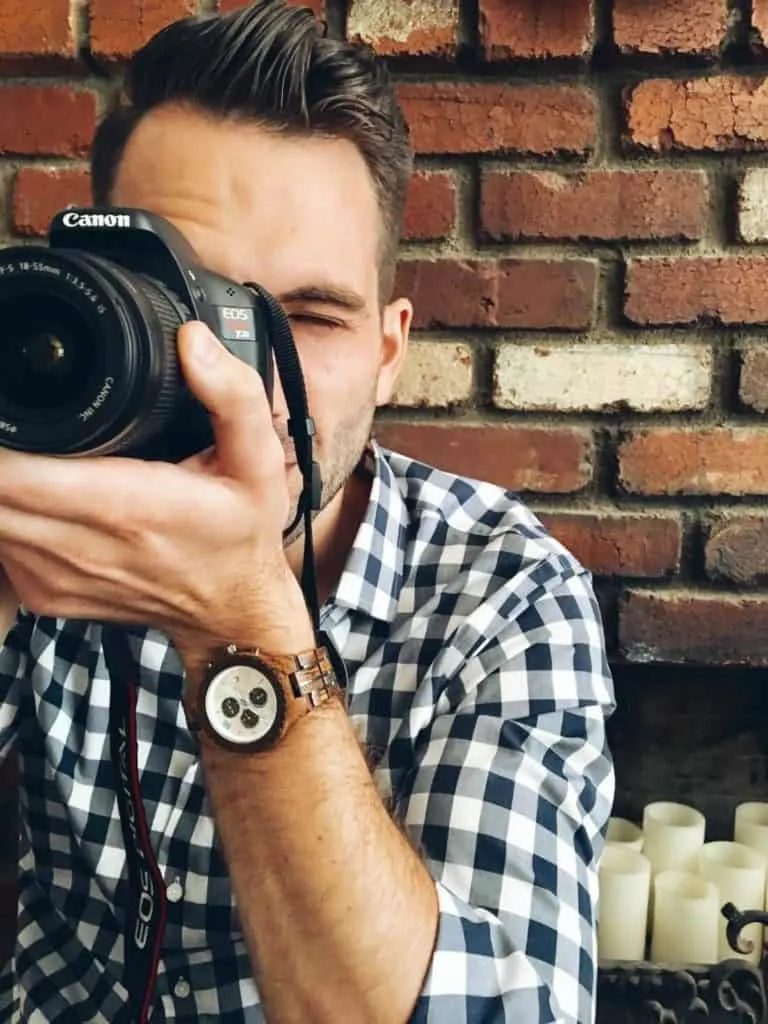 Man holds camera to take shot.