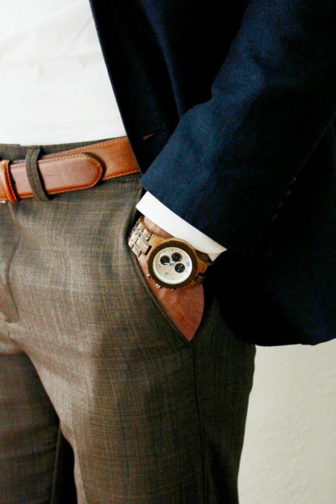Man wears jord watch with hand in pocket.
