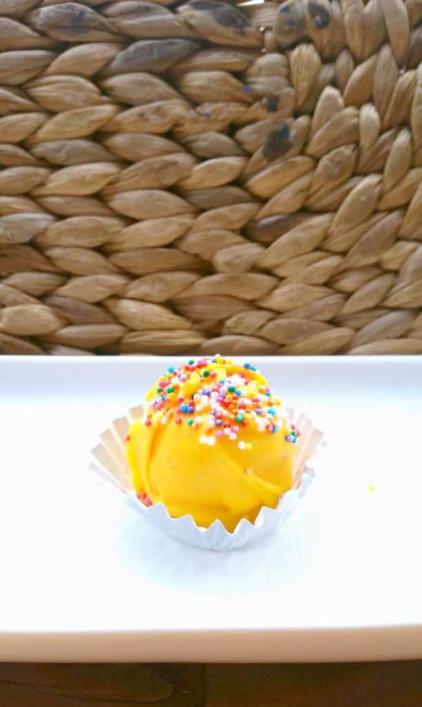 yellow cake pop on a plate for a gender reveal party