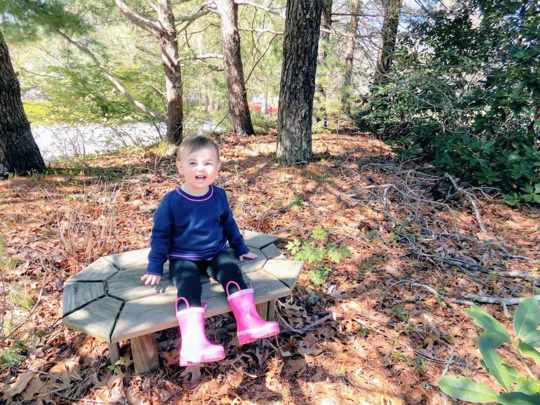 Toddler girl stays safe from ticks in woods.