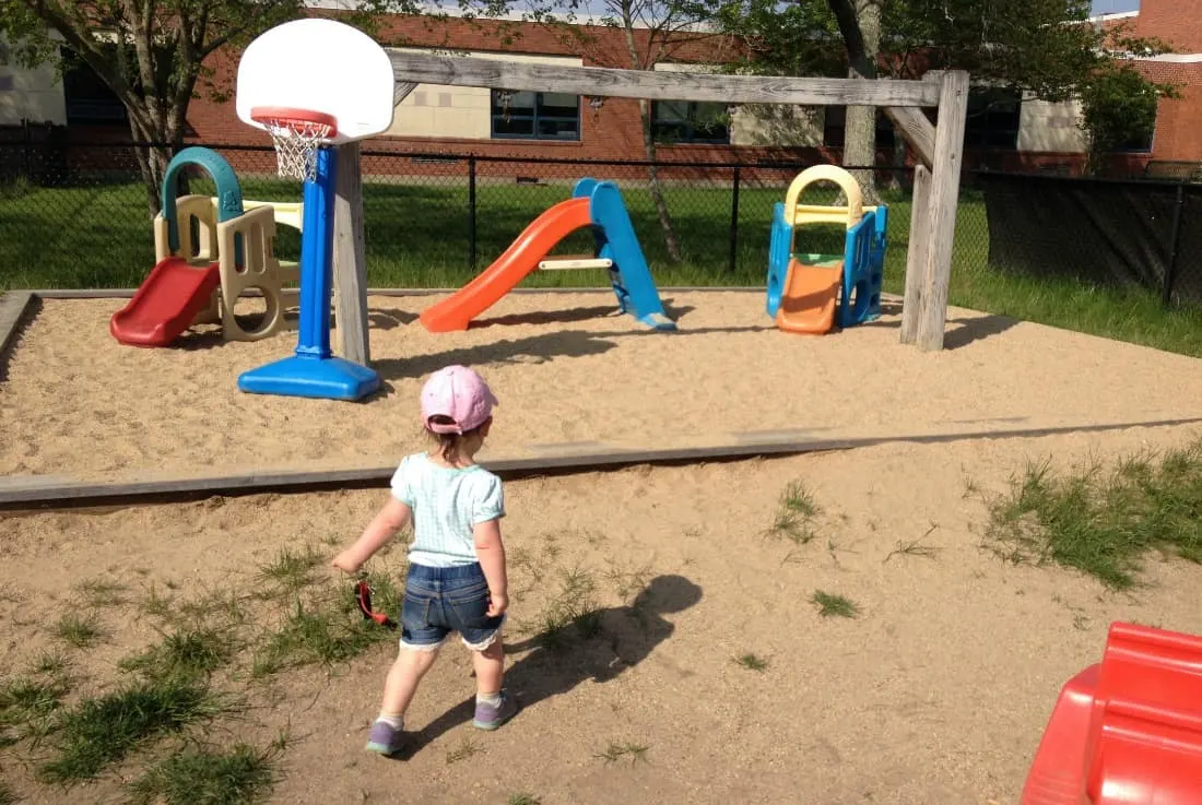 Little girl plays at playground.