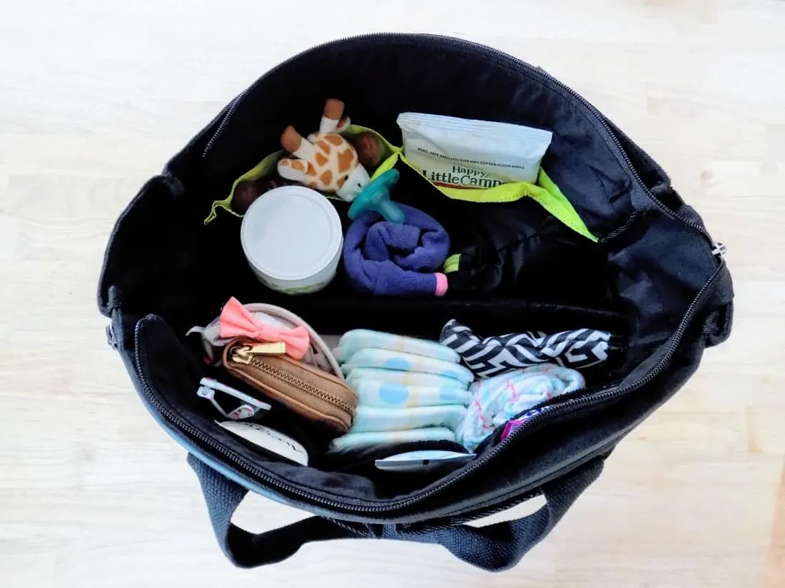 Diaper bag filled with baby items.