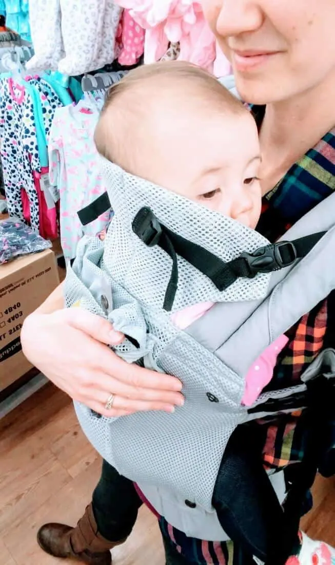 Baby looks out over top of baby carrier.