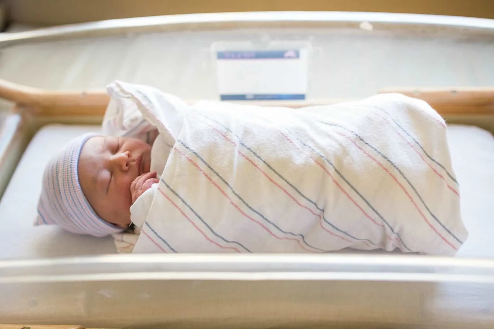 Newborn swaddled in hospital blanket.
