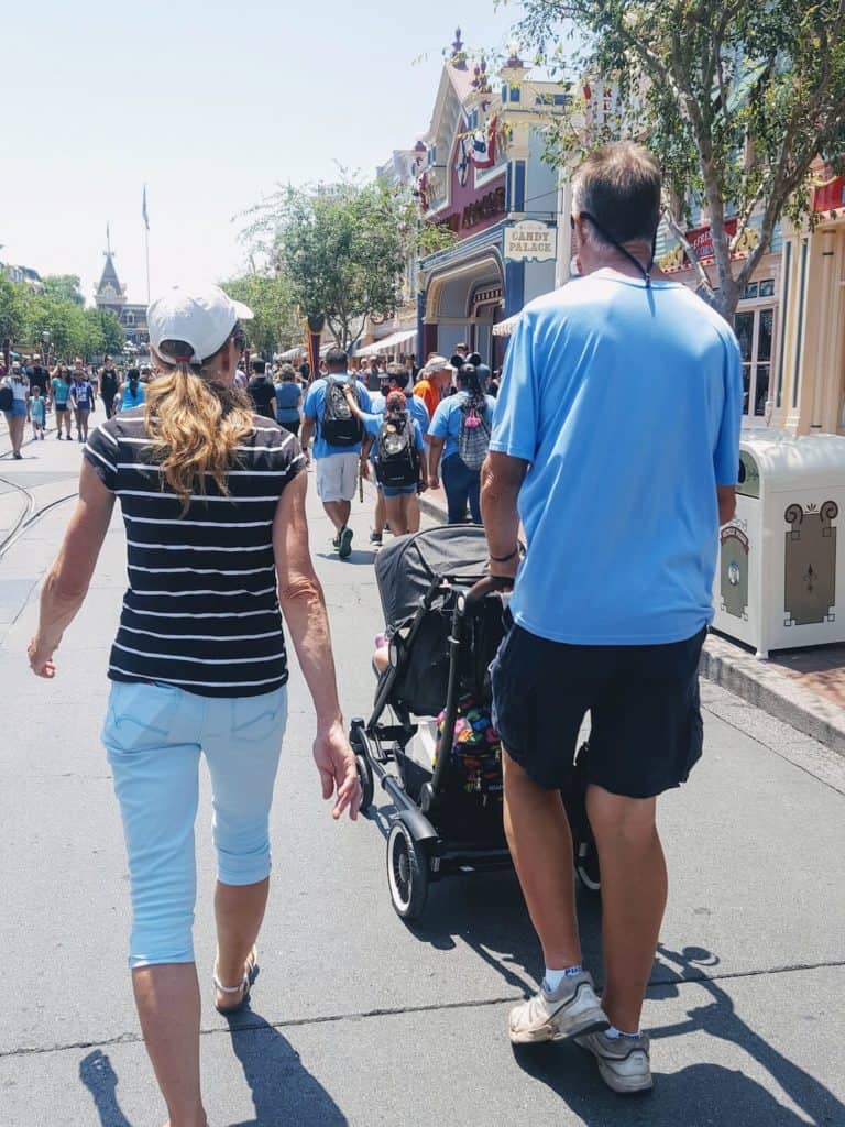 Family walks down streets of Disney World.