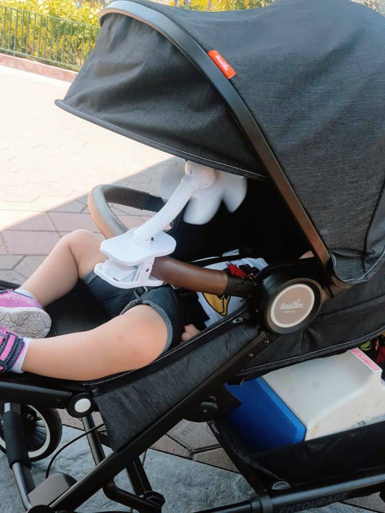 Toddler girl reclines in Entourage stroller at Disney World.