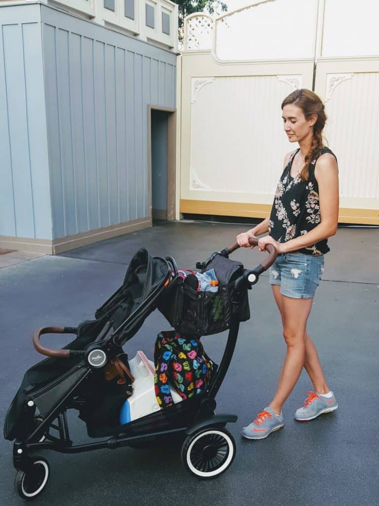 Woman pushes stroller at Disney.