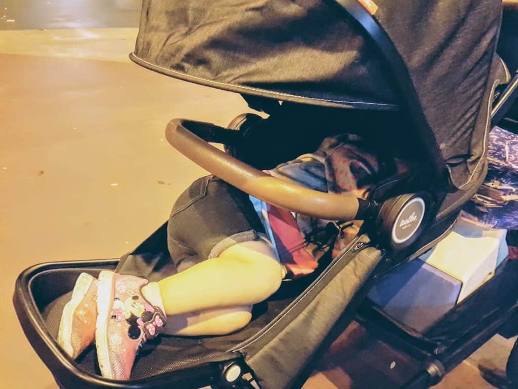 Little girls sleeps in stroller.