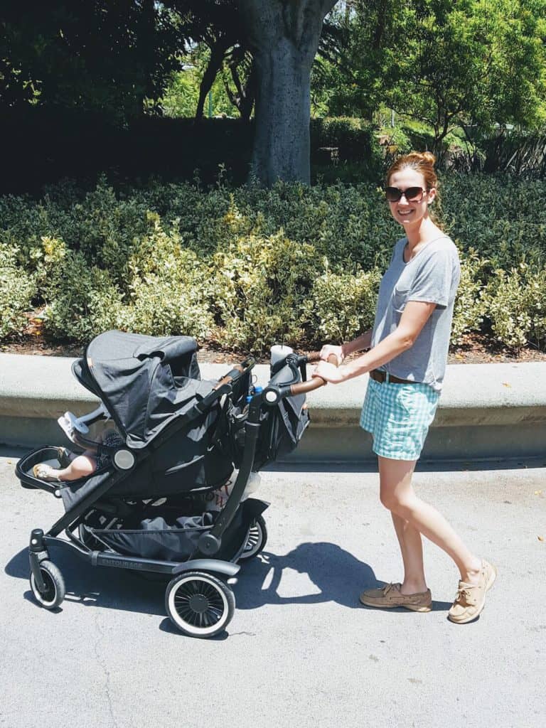 Mom pushes Austlen stroller down Disney street.