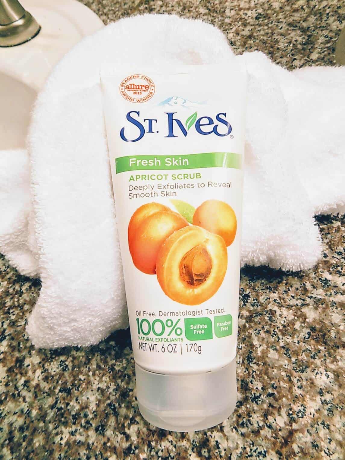 St Ives Fresh Skin Apricot Scrub in front of white blanket.