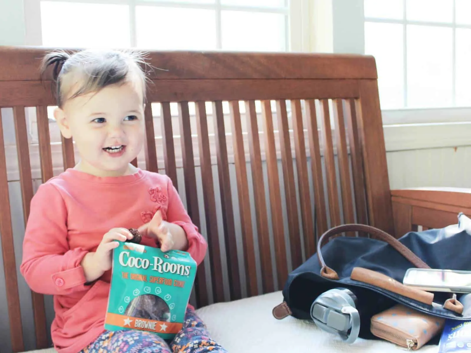Toddler girl holds bag of Coco-Roons.