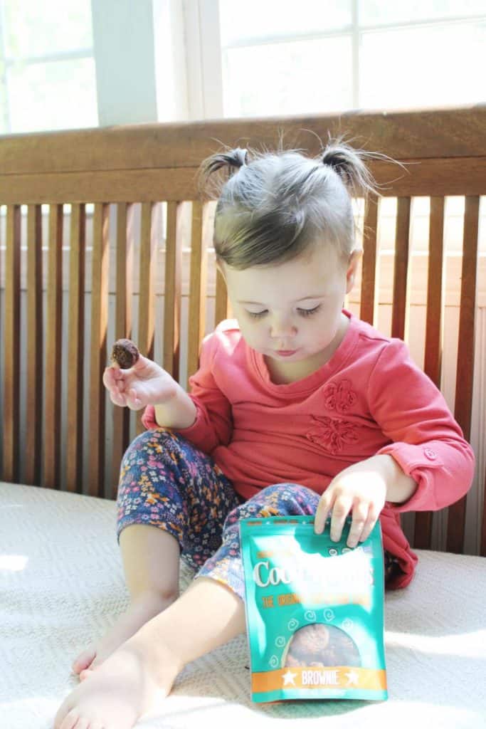 Child eats Coco-Roons from bag.