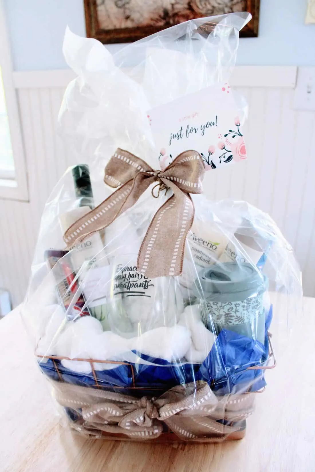 Gift basket for moms wrapped in clear paper.
