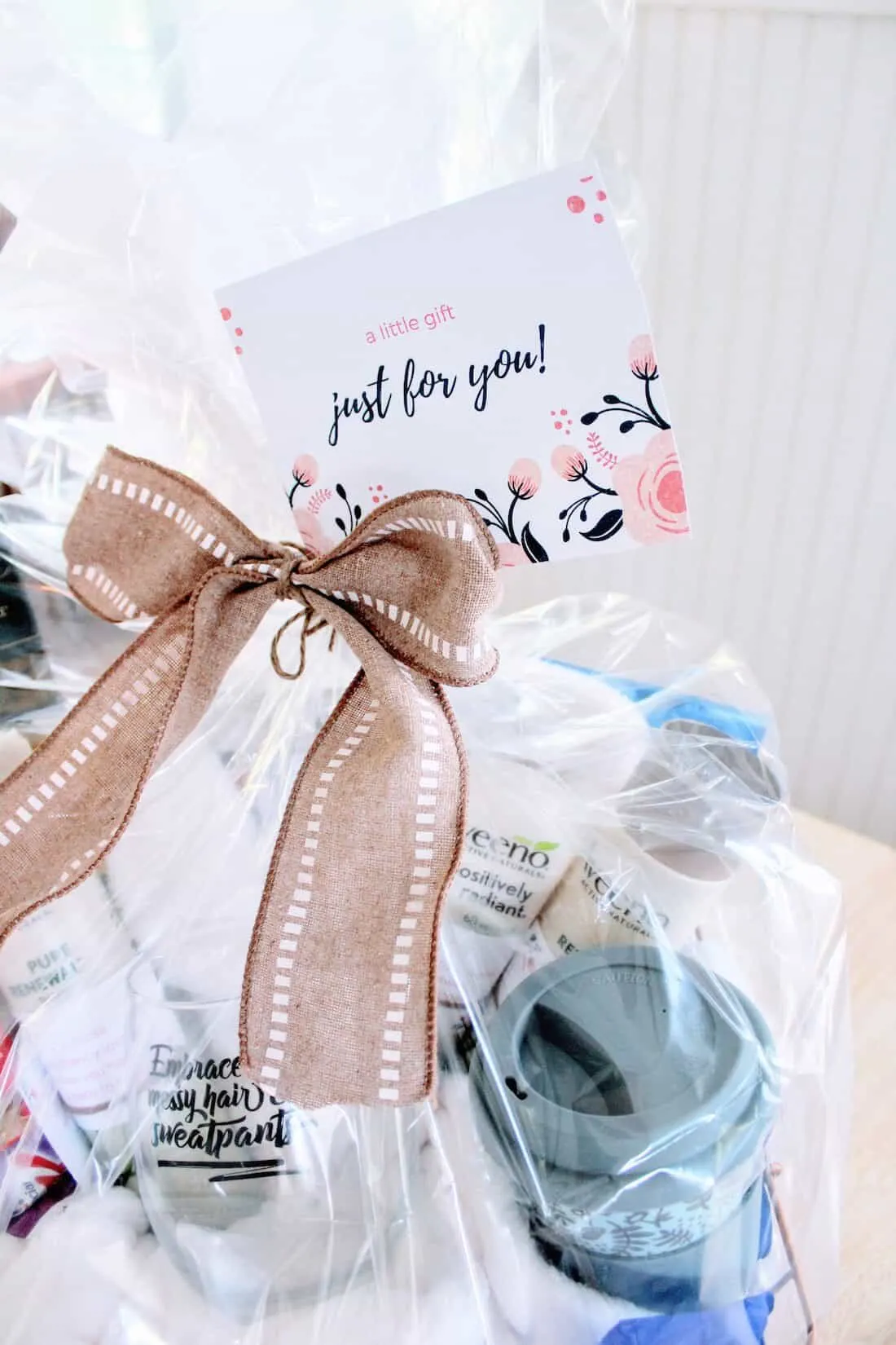 Gift basket with card and ribbon on top.