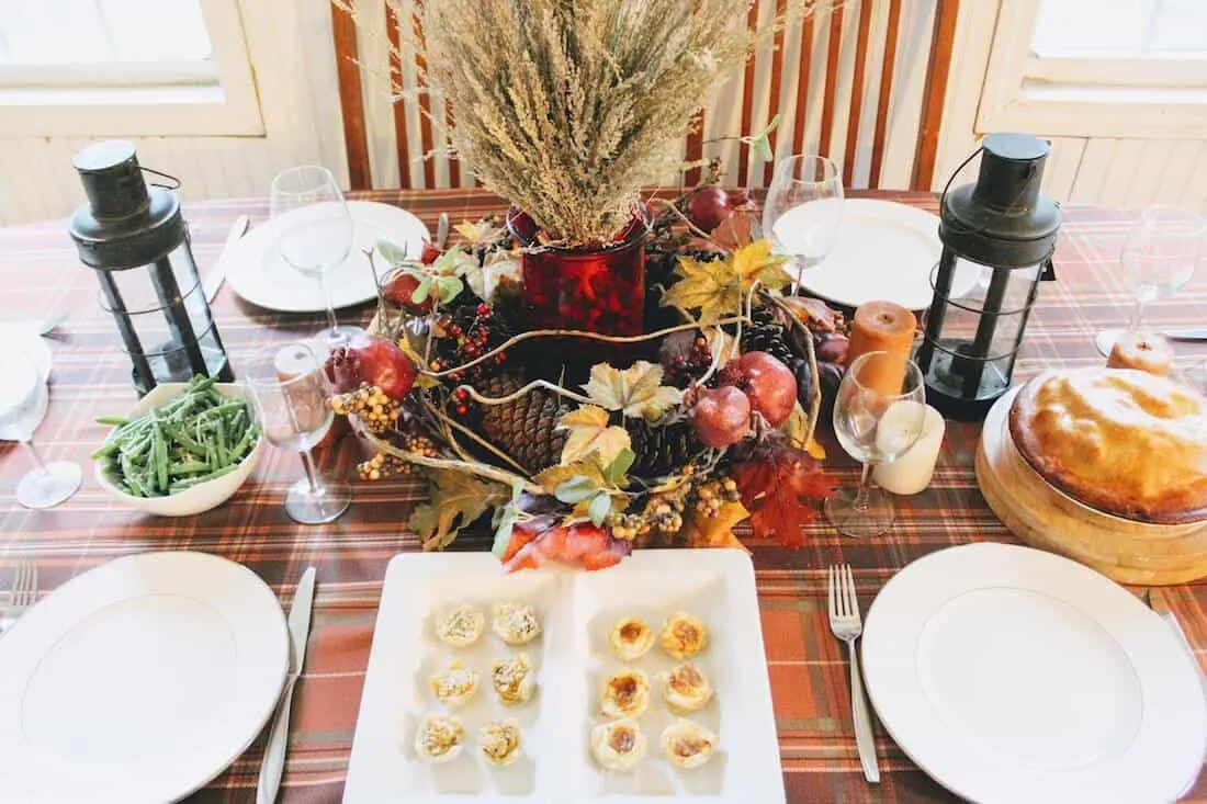 Thanksgiving food and plates on table.