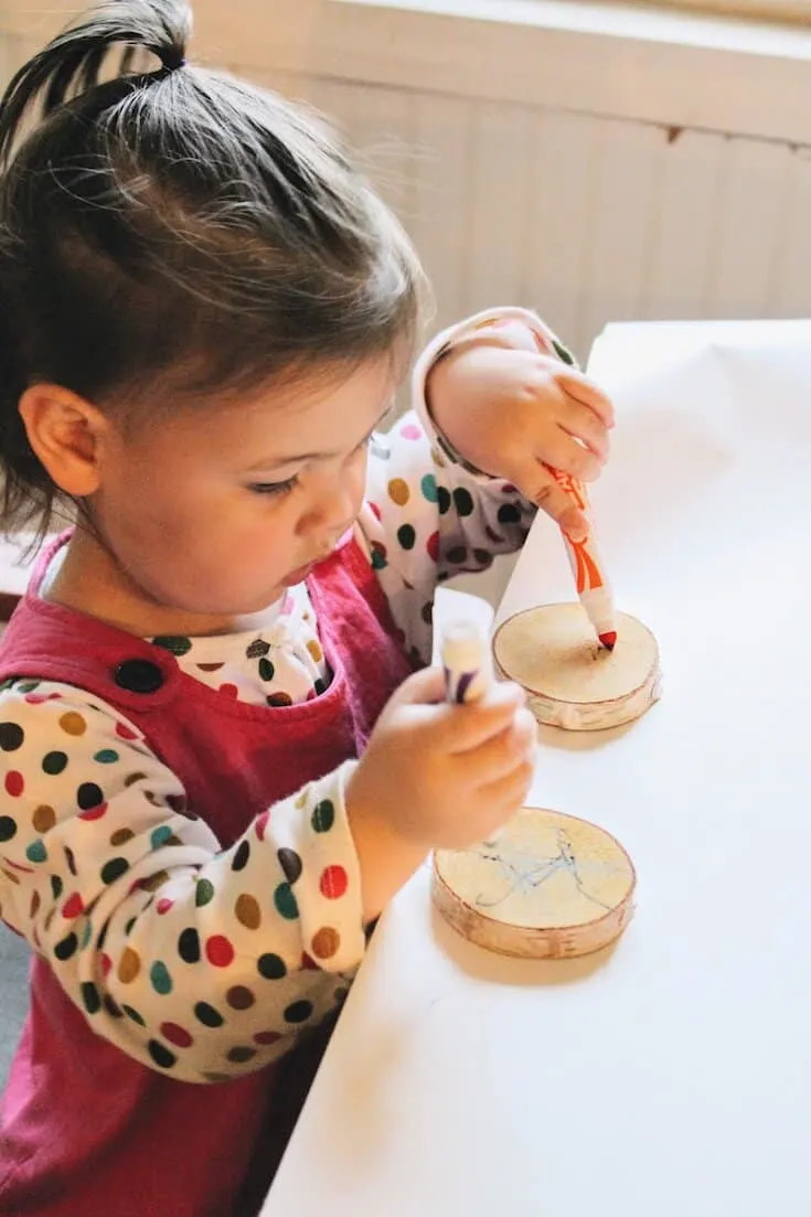 Toddler makes DIY Thanksgiving table decor.