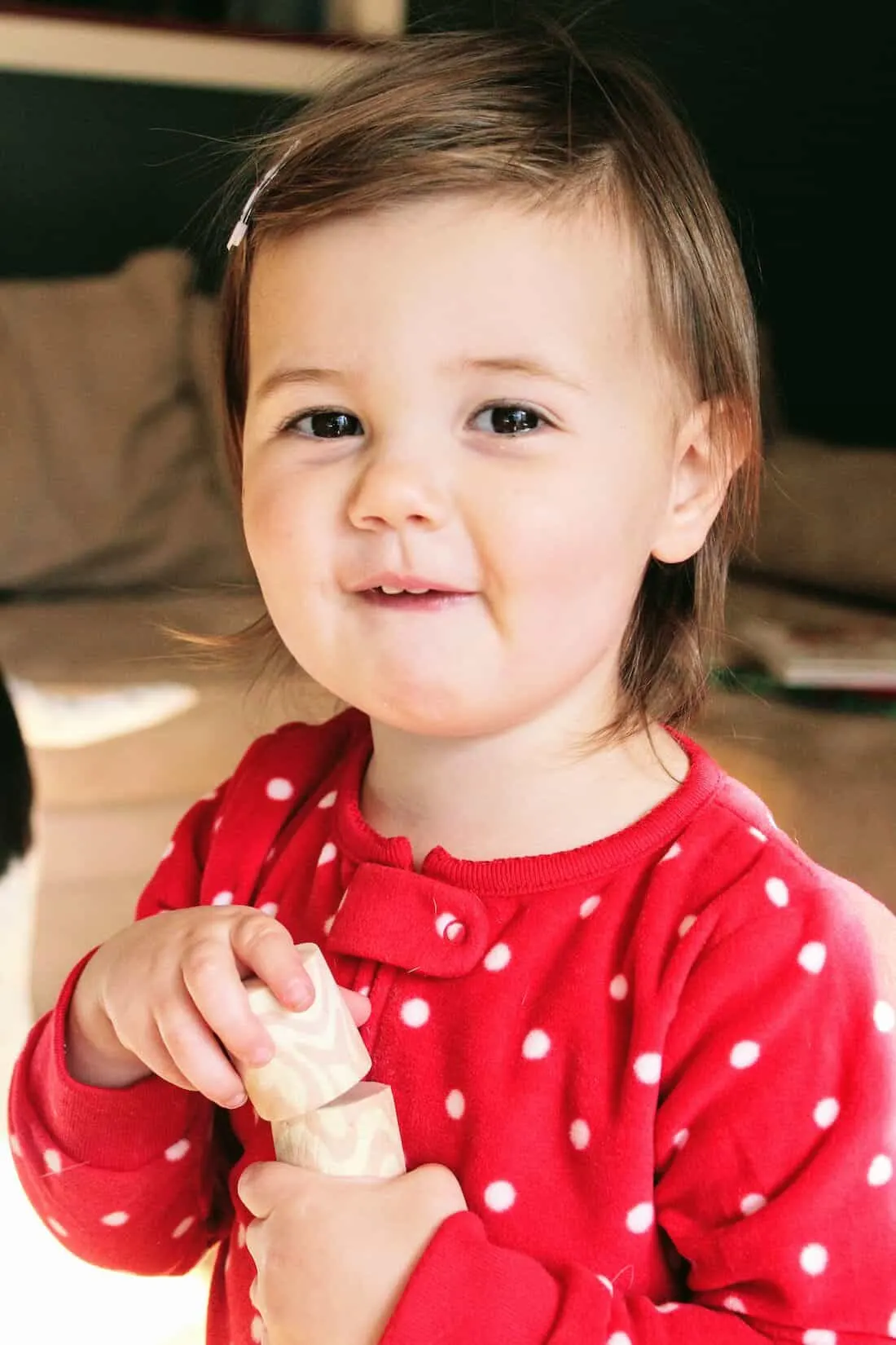 Toddler girl in Christmas PJs.