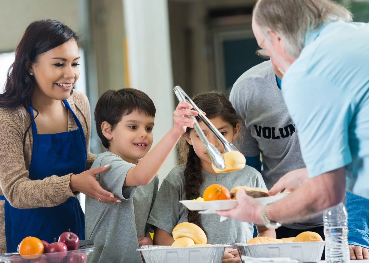 A family serving food at a soup kitchen.