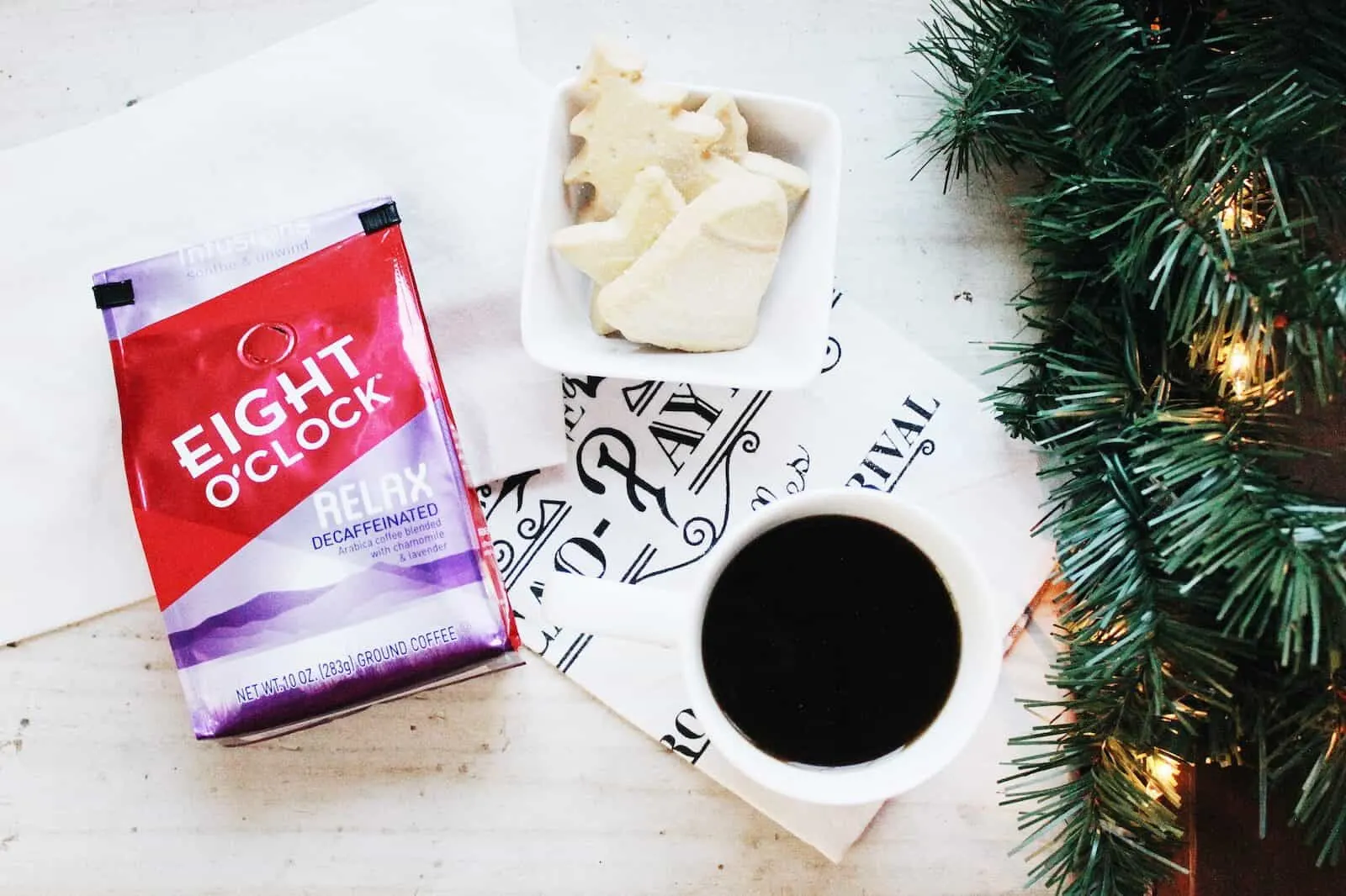 Christmas cookies next to mug of coffee.