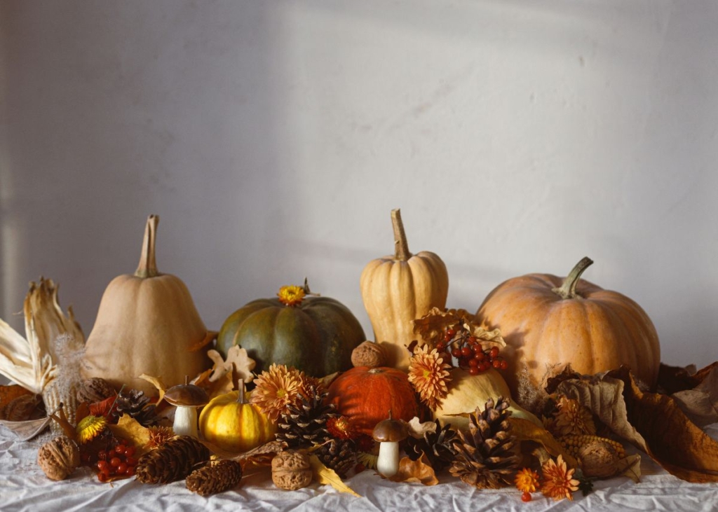 Pumpkins and fall foliage on a table centerpiece.