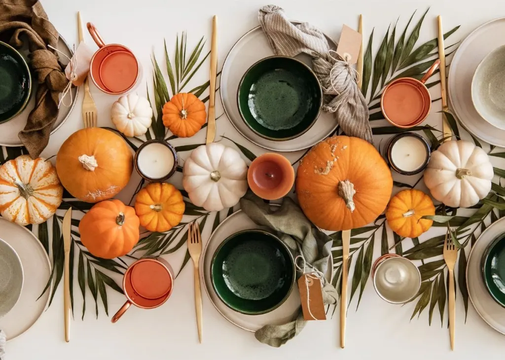 Green, orange, and tan natural Thanksgiving table decor and centerpieces.