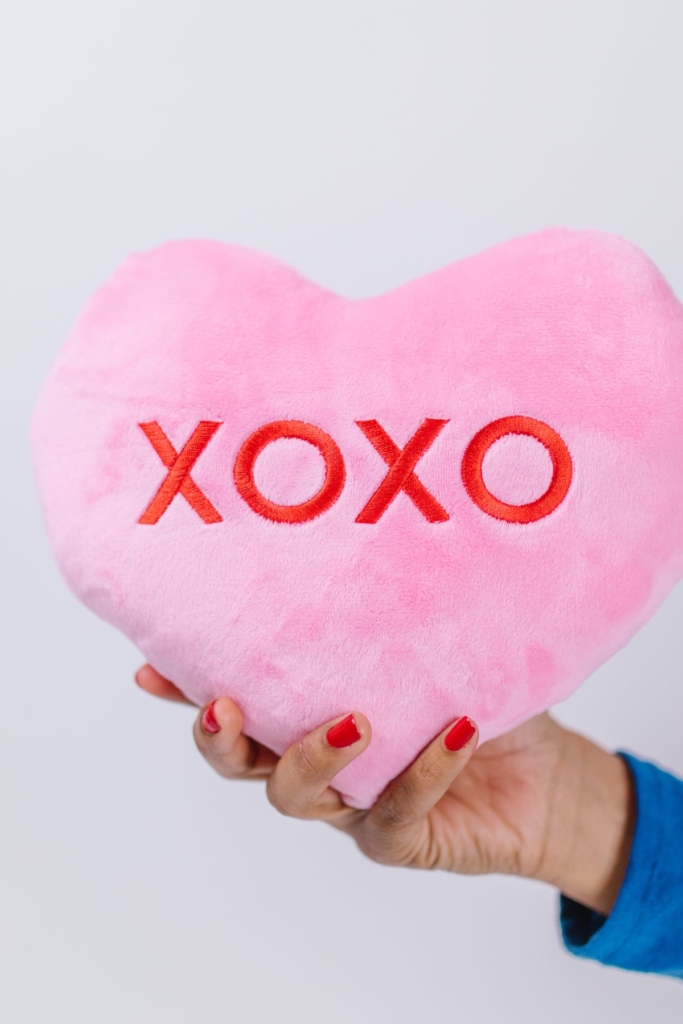 A pin confection hearts pillow with "xoxo" in red.