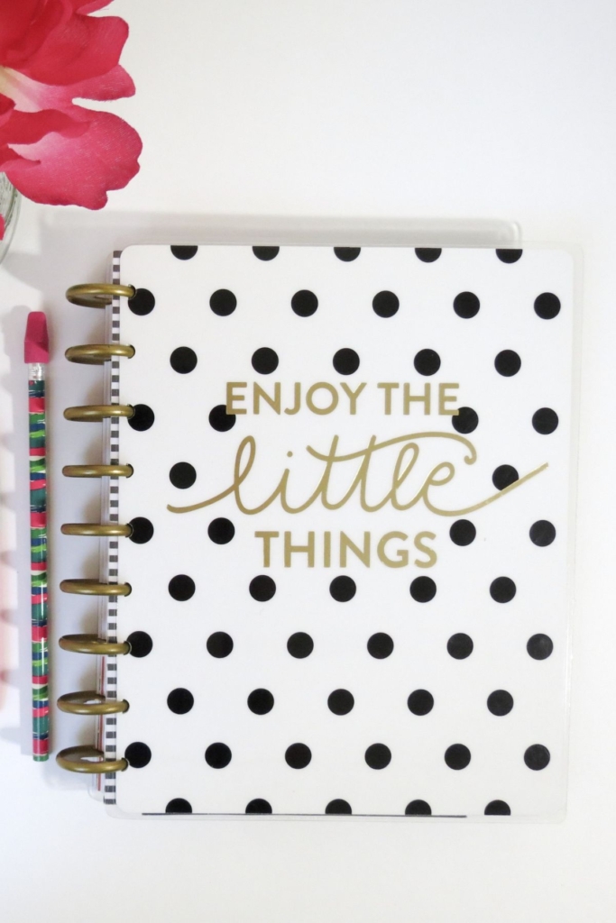 A black and white polka dot spiral bound journal that says "Enjoy The Little Things" on the front.