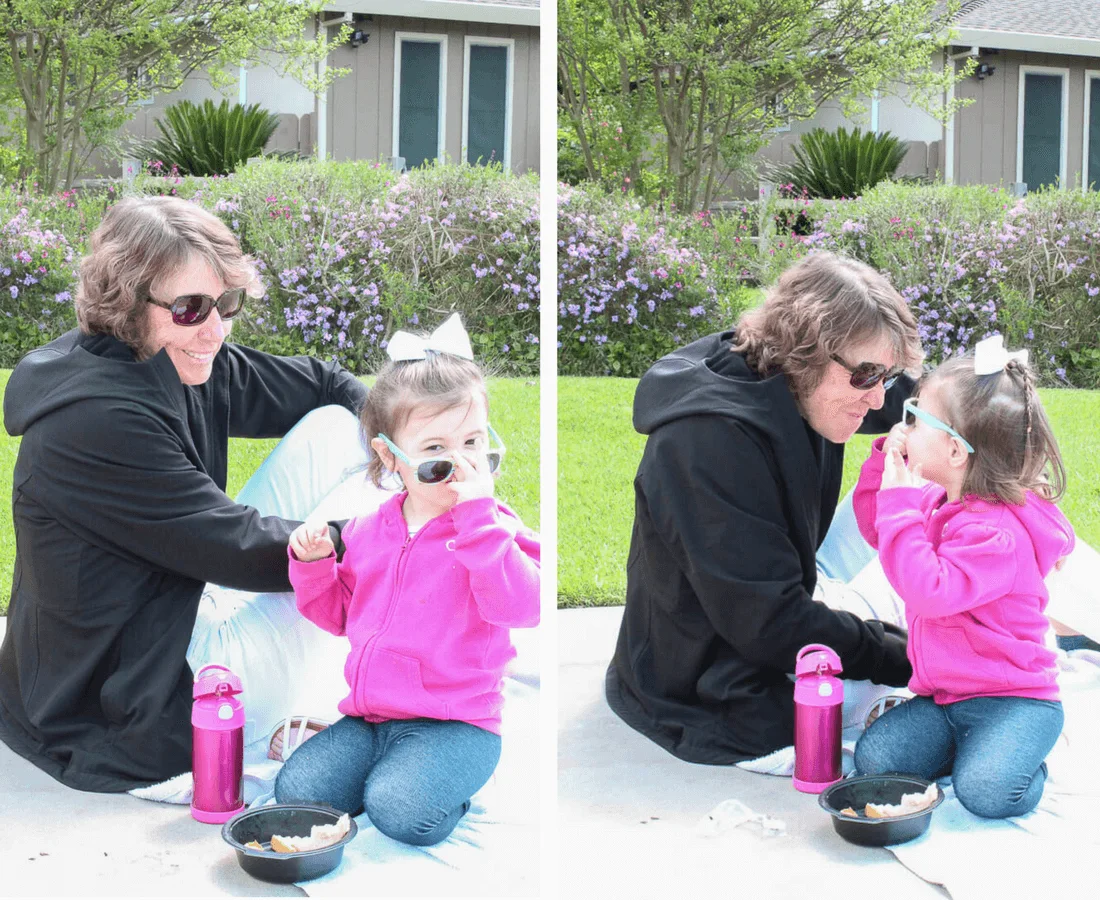 Woman eats outside with grandaughter.