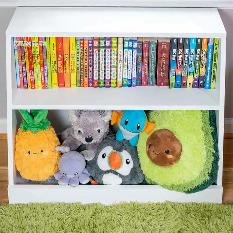 A DIY white bookshelf for kids with toy storage.