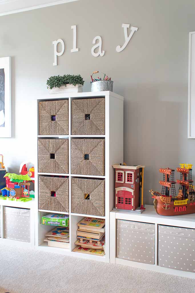 Toy storage shelves with wicker baskets.