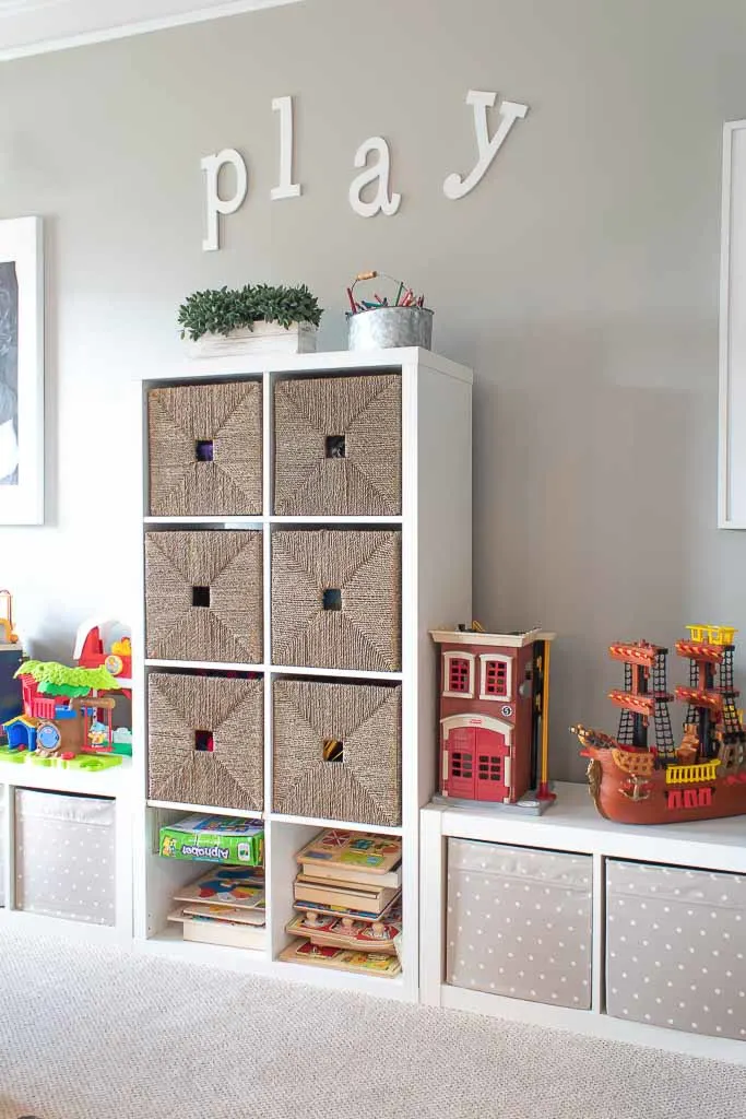 Toy storage shelves with wicker baskets.