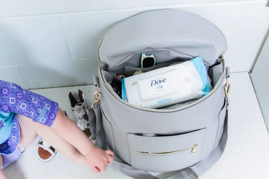 Diaper bag with Dove brand wipes inside.