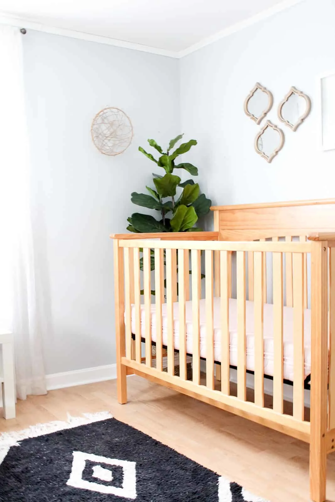 View of crib in modern nursery.