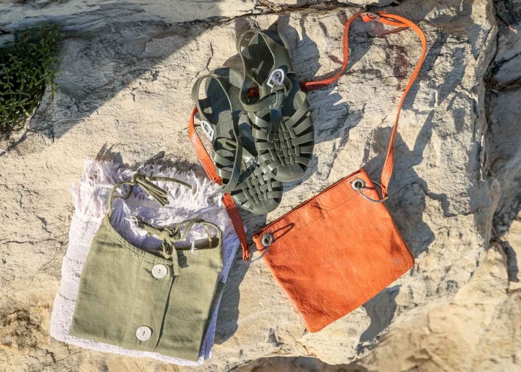 Green, gray, and orange outfit on a sandy beach.