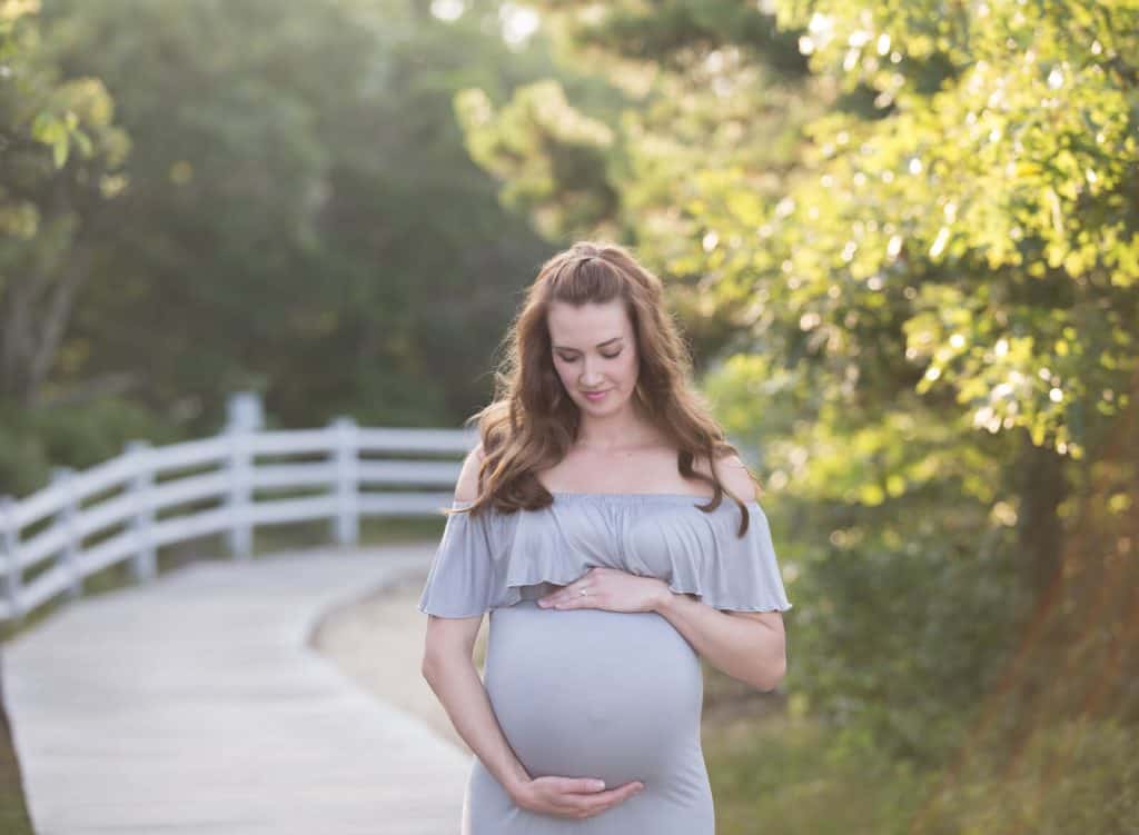 Woman poses for maternity photo shoot on Cape Cod.