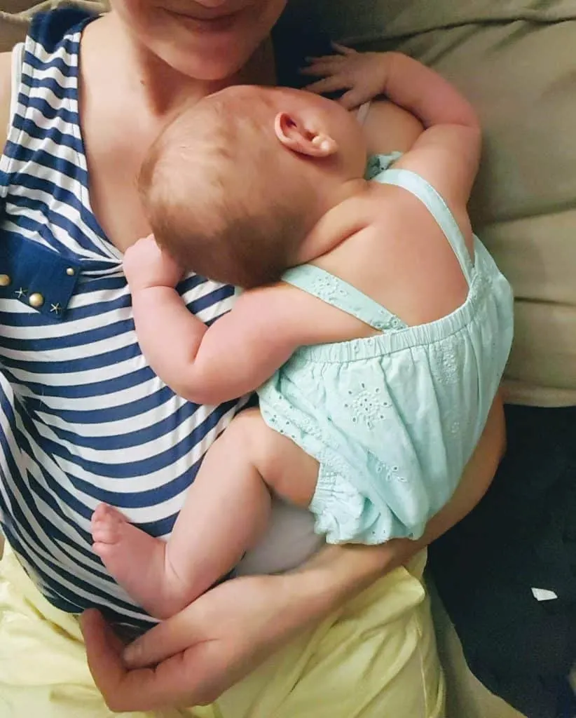 Mother holds newborn baby.