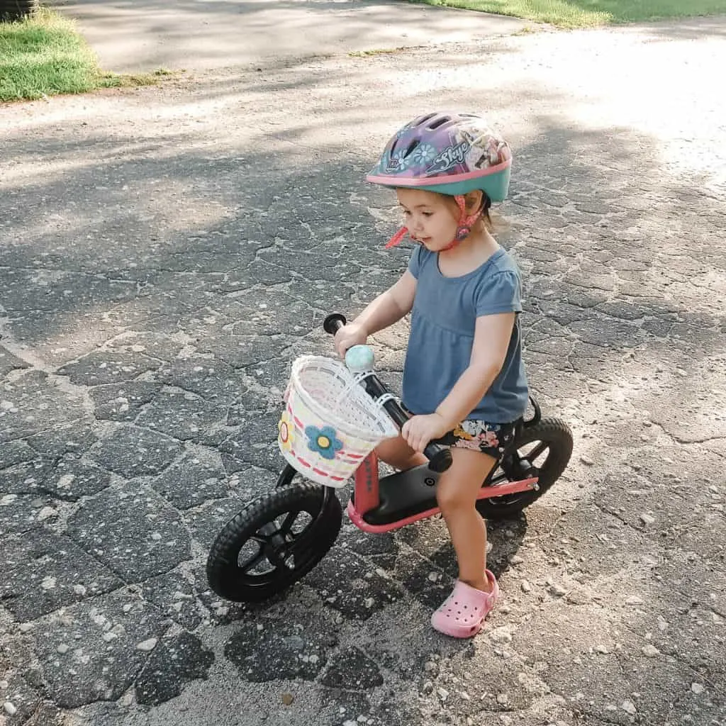 Toddler girl on bicycle.