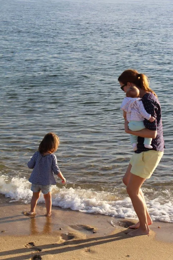 Family plays next water at beach.