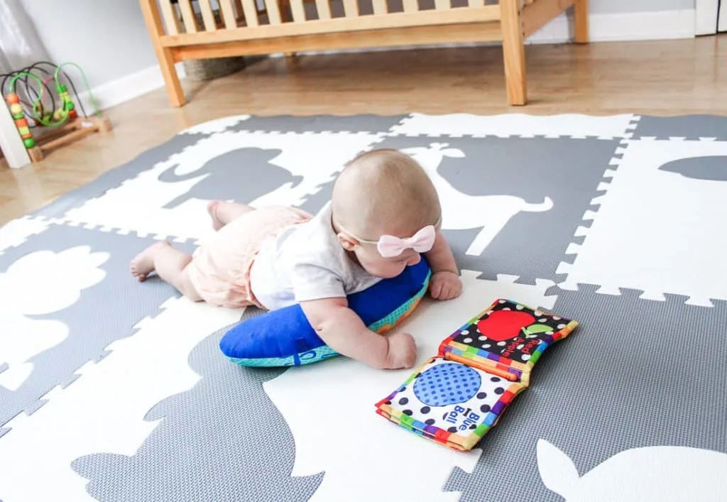 Baby plays with fabric book during tummy time.