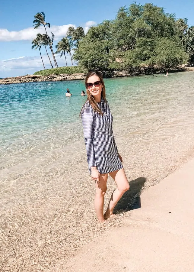 Woman stands on Hawaii beach.