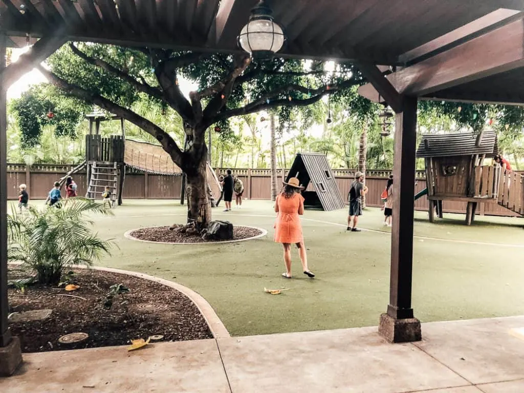 Children play on playground at Disney resort in Hawaii.