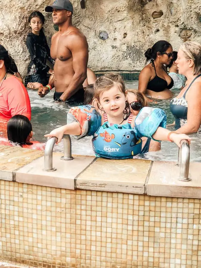 Child plays in pool at Disney water park.