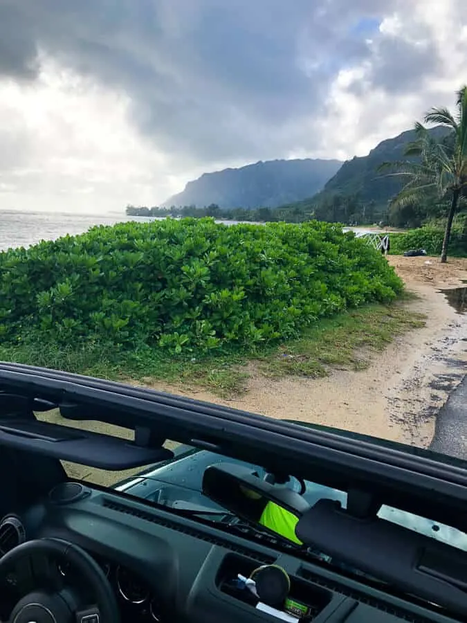 View through vehicle windshield of Hawaiian ocean.