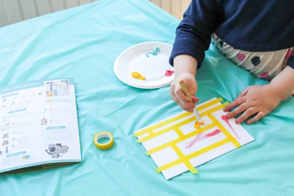 Girl makes art deign using products for spring for kids and moms.