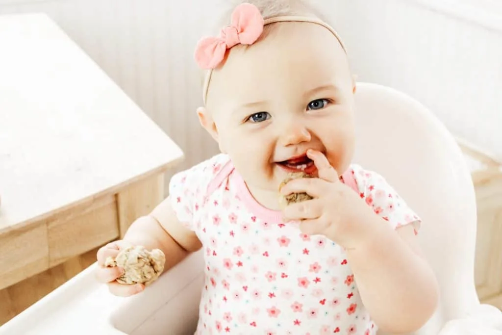 Baby eats muffins for baby led weaning.