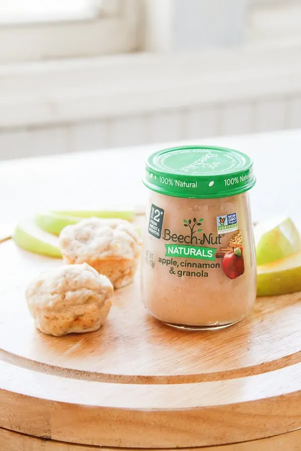 Beech Nut baby food jar next to weaning muffins and fruit.