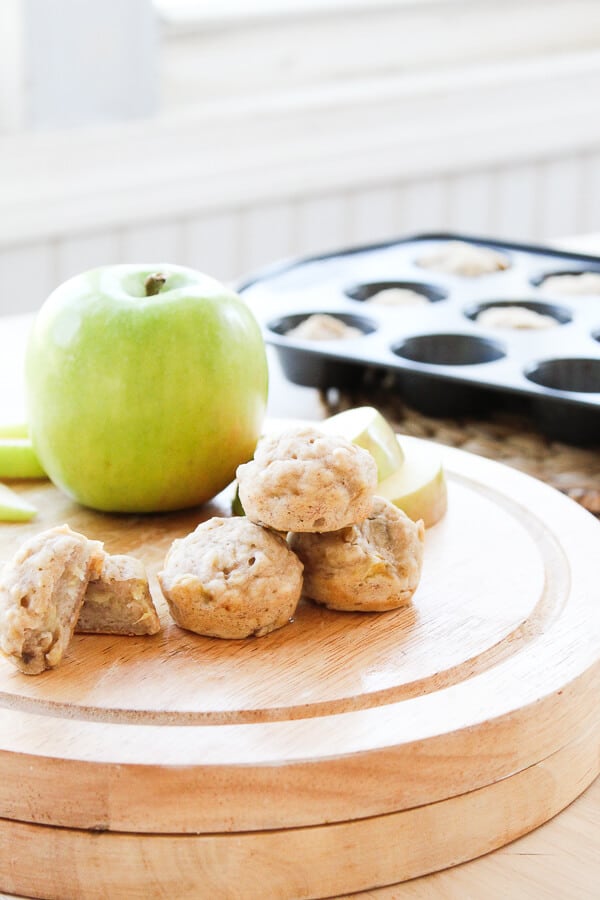 A plate of fruit sitting on a table, with Baby muffins